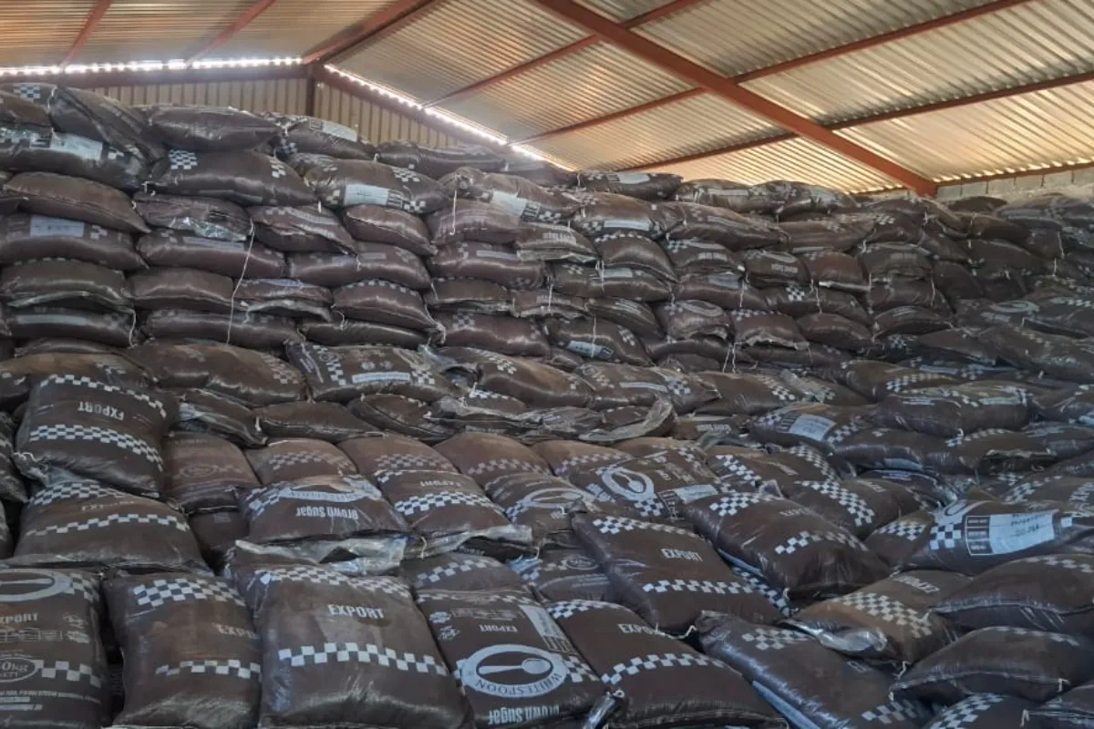 Sacks stacked high inside a roofed store. The sacks show a brand name; owner has approved showing this photo.